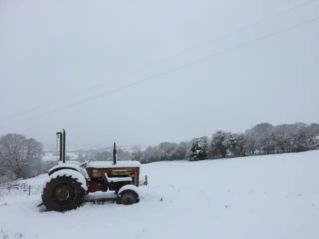 Tractor in snowy field