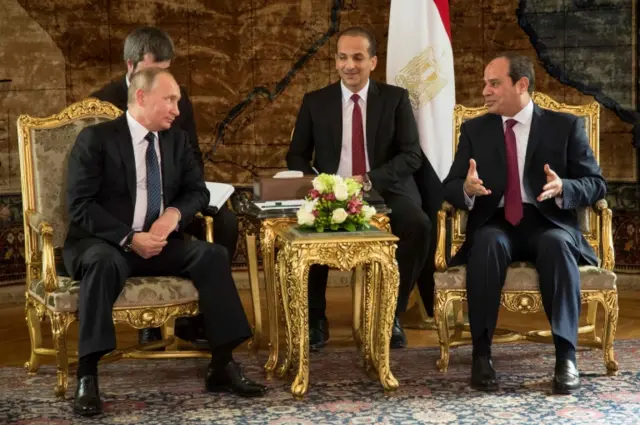 Egyptian president Abdel Fattah el-Sisi (R) speaks with his Russian counterpart Vladimir Putin (L) prior to their meeting in Cairo on December 11, 2017.