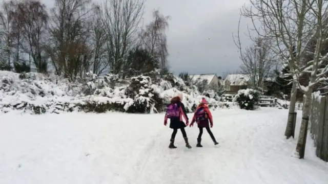 Children walk to school in snow in Inverness