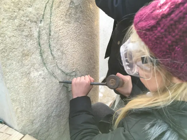 Child carving stone