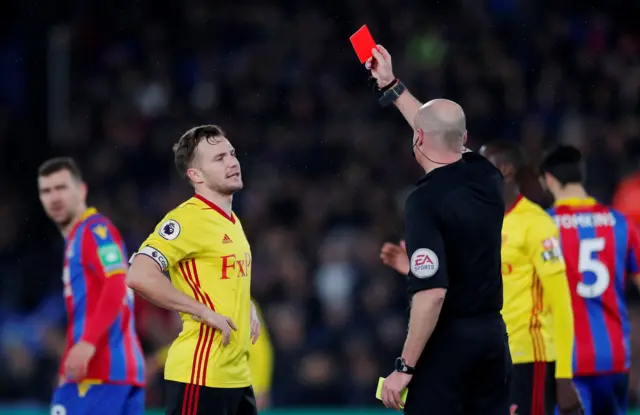 Tom Cleverley is shown a red card