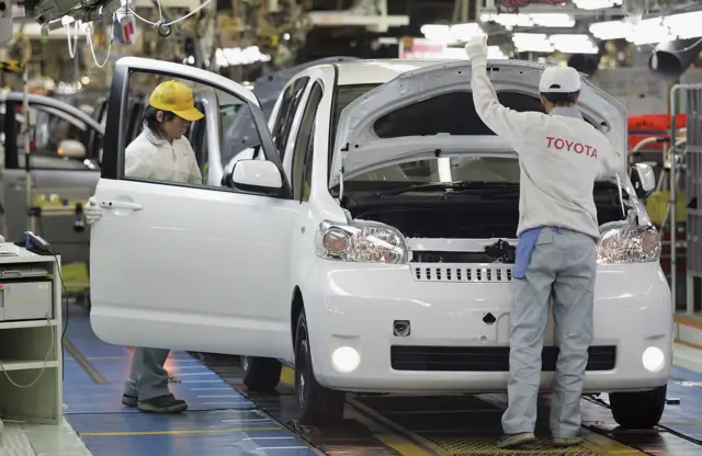 Toyota employees work on the production line at a Toyota assembely plant in Japan