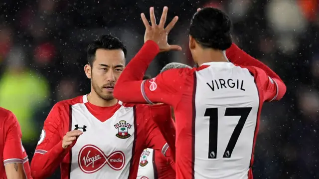 Maya Yoshida celebrates with Virgil van Dijk