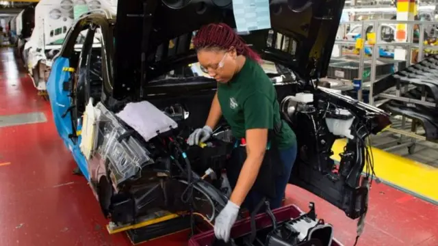 Woman working in automobile factory