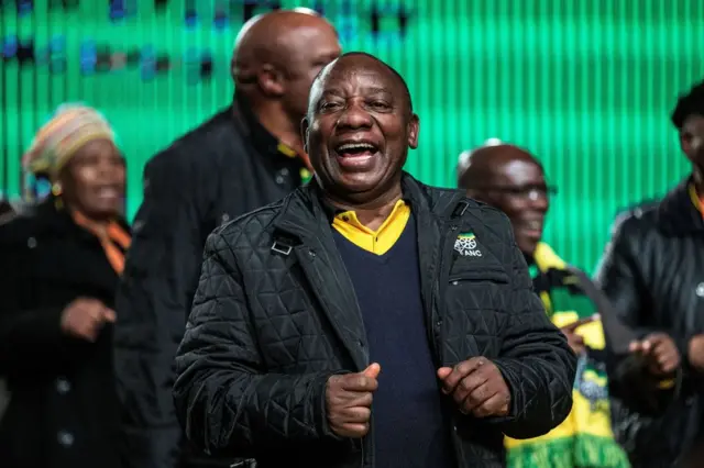 South African deputy Cyril Ramaphosa dances at the end of the opening remarks of the opening session at the ANC'S Fifth Annual Policy Conference in Johannesburg on June 30, 2017.