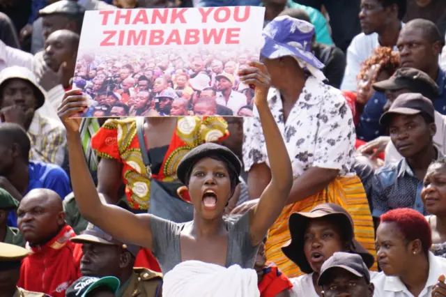 A supporter holds a sign during the Inauguration ceremony of the newly sworn-in President at the National Sport Stadium in Harare, on November 24, 2017.