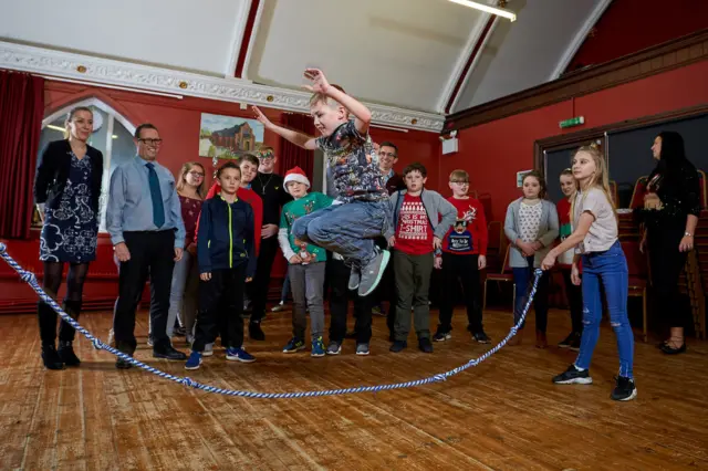 Children at the youth centre enjoying skipping activities