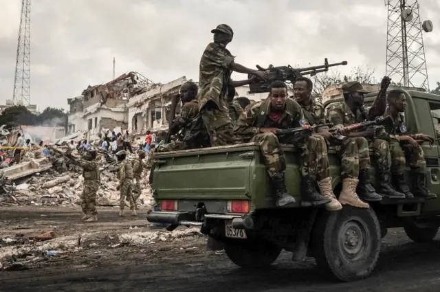 Somali soldiers patrol on the scene of the explosion of a truck bomb in the centre of Mogadishu, on October 15, 2017.