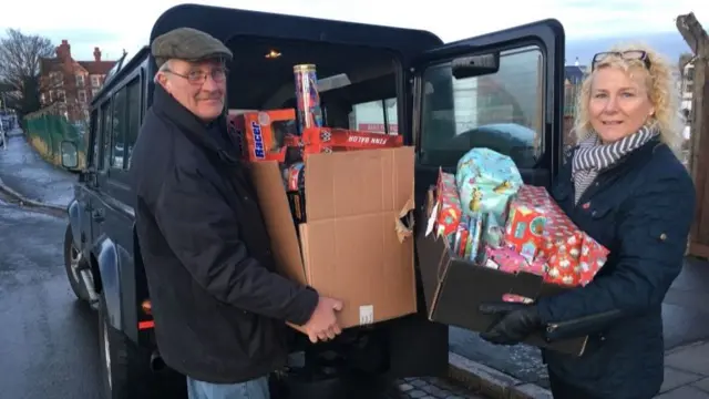 People put presents in a car