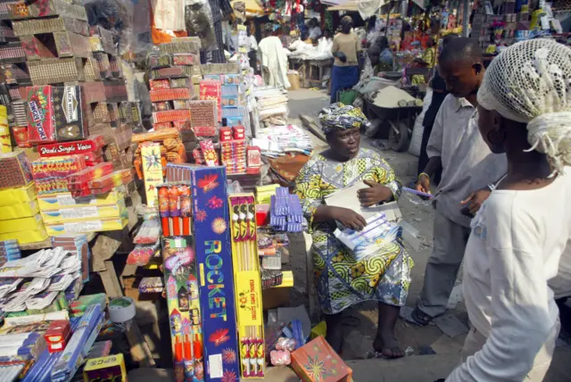 A vendor sells firecracker and fireworks at the burstling Cater bridge connecting Lagos Island with Mainland at Idumota in Lagos 21 December, 2006.