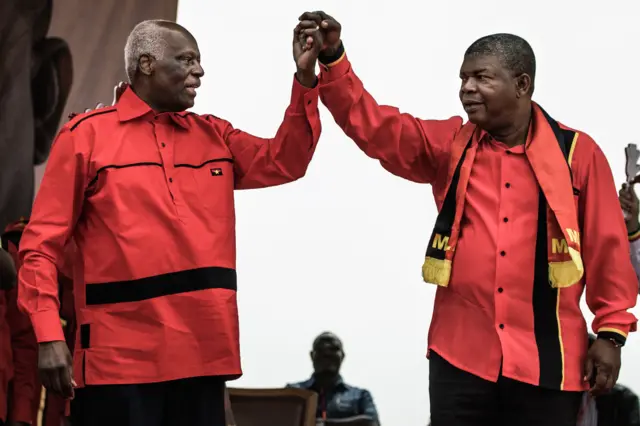 Jose Eduardo dos Santos and MPLA candidate to the presidency Joao Lourenco hold hands during the closing campaign rally in Luanda, on August 19, 2017.