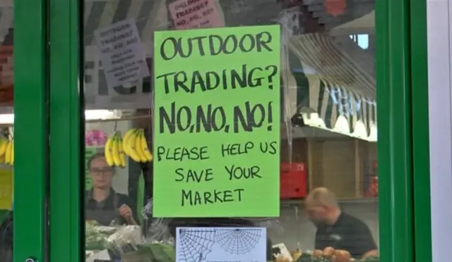 Scunthorpe market with sign against move