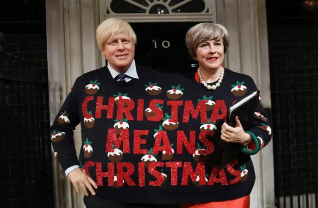 Boris Johnson and Teresa May waxworks wearing Christmas jumper