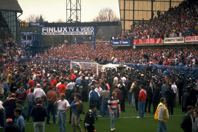 Fans on the pitch at Hillsborough as the disaster unfolded