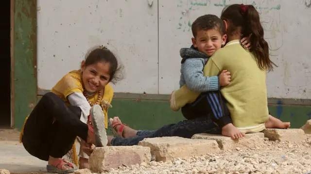 Syrian refugee children play at the Zaatari refugee camp