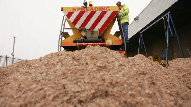 Road gritter and a pile of salt