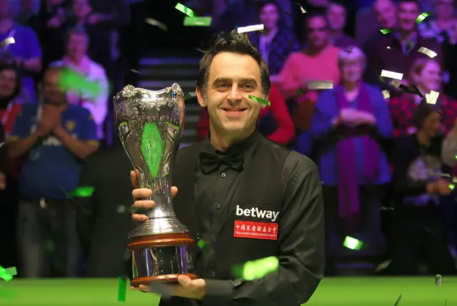 Ronnie O'Sullivan poses with the UK Championship trophy after beating Shaun Murphy in the 2017 final