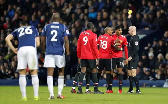 Marcus Rashford receives a yellow card