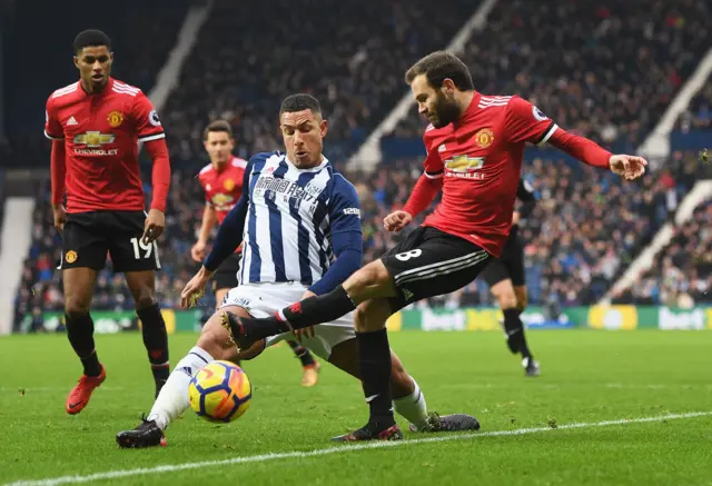 Juan Mata of Manchester United is challenged by Jake Livermore of West Bromwich Albion