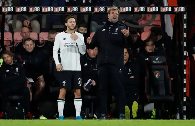 Adam Lallana waits to come on