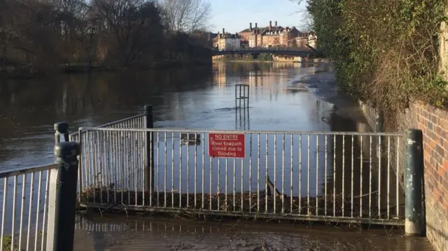 Footpath flooded by river