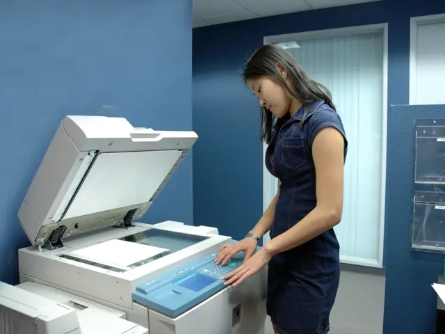 Young woman using a photocopier