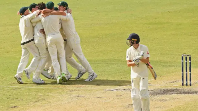 Chris Woakes leaving the pitch as Australia celebrate