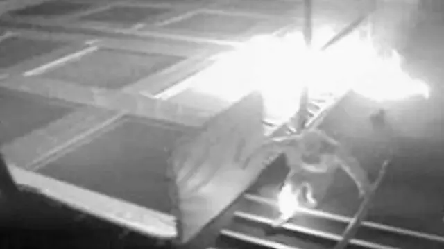 CCTV image of man running from fire