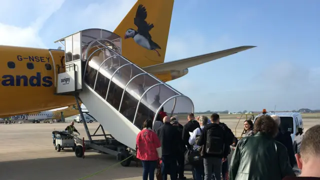 Aurigny passengers board an aircraft