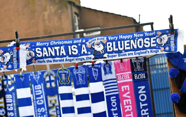 A scarf reads Santa is a blue nose