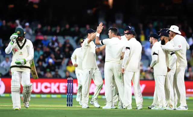 England celebrate after taking the wicket of Usman Khawaja