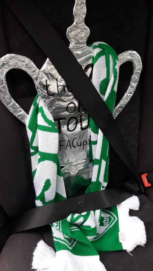 FA Cup replica under a seatbelt