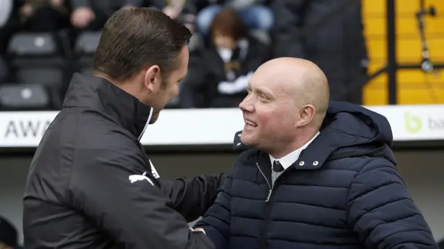 The two managers shake hands