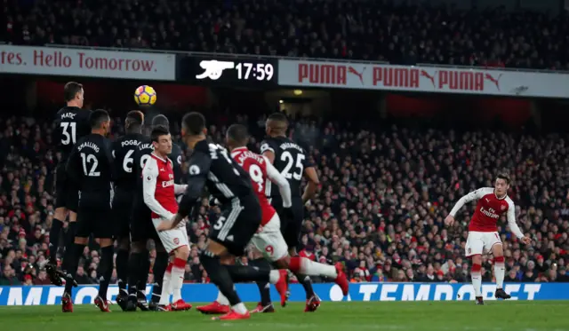 Mesut Ozil takes a freekick for Arsenal