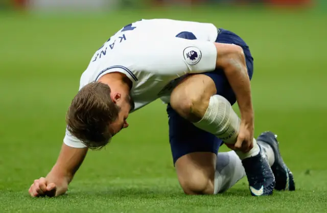 Harry Kane of Tottenham Hotspur goes down holding his ankle