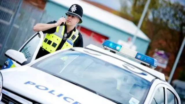 Police officer by car