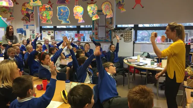 Pupils speak to their fellow students in Uganda over Skype