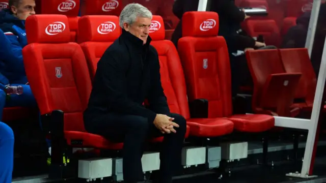 Mark Hughes looking on from dugout during West Ham game