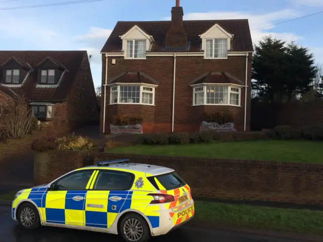 Police car parked outside house in Buckton