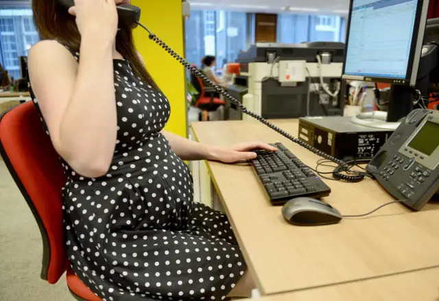 Pregnant woman in an office