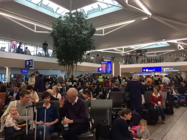 Travellers sitting in the terminal