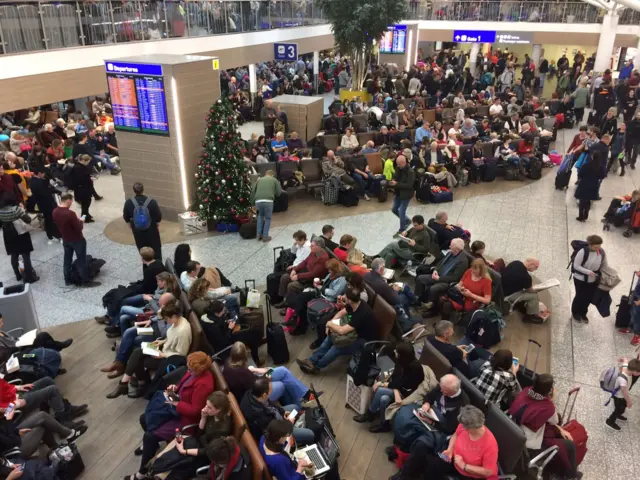 Travellers sitting in the terminal