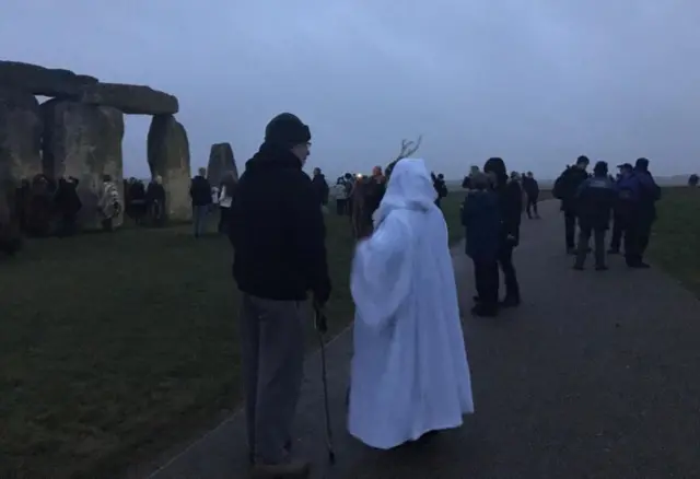 Druid and people at Stonehenge