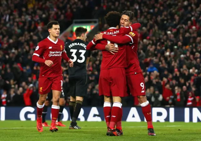 Liverpool's Roberto Firmino celebrates with team-mate Mohamed Salah.