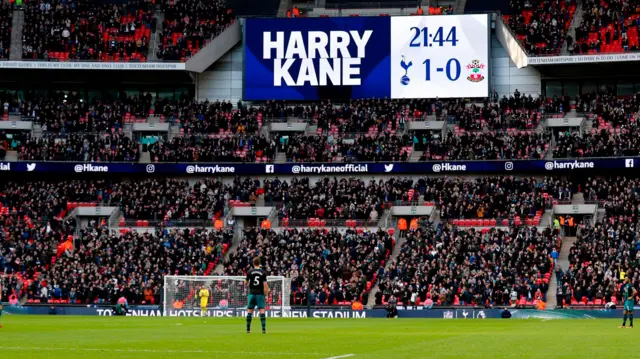 The scoreboard shows the name of Harry Kane