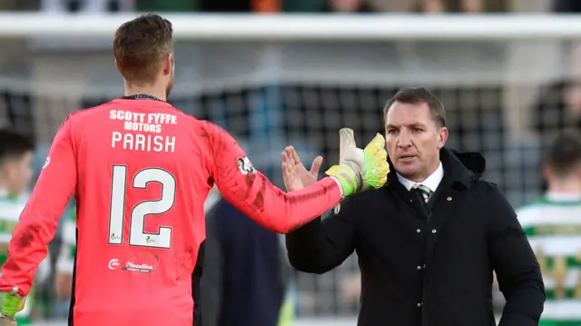 Dundee goalkeeper Elliot Parish congratulates Celtic boss Brendan Rodgers