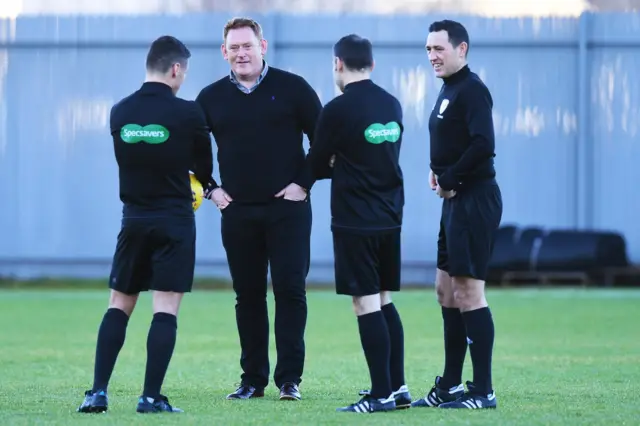 Livingston manager David Hopkin talks to the match officials