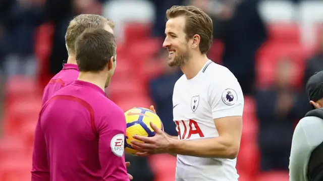 Harry Kane of Tottenham Hotspur collects the match ball