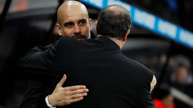 Pep Guardiola and Rafa Benitez embrace before kick-off