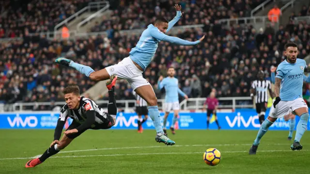 Dwight Gayle goes down under a challenge from Danilo